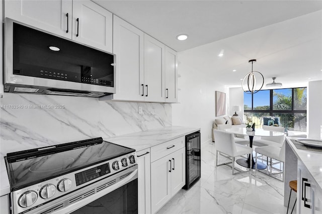 kitchen featuring wine cooler, white cabinetry, marble finish floor, and appliances with stainless steel finishes