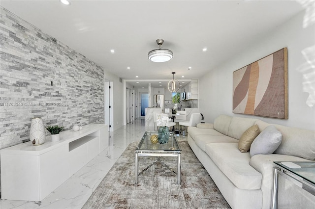 living room featuring recessed lighting and marble finish floor