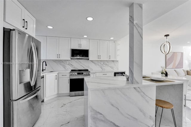 kitchen featuring light stone counters, marble finish floor, appliances with stainless steel finishes, and white cabinets