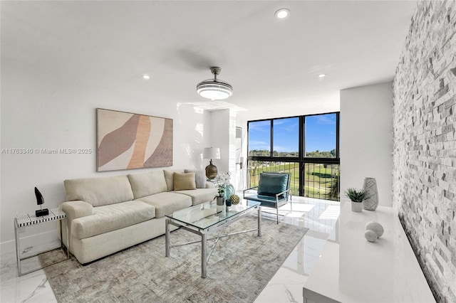 living area with recessed lighting, marble finish floor, and floor to ceiling windows
