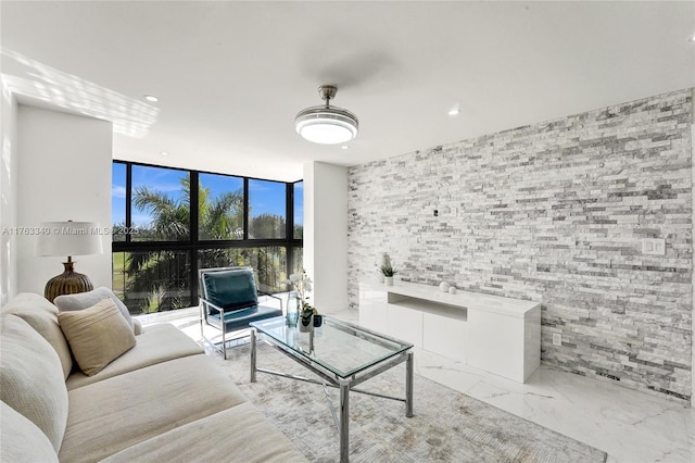 living room featuring marble finish floor, recessed lighting, and expansive windows