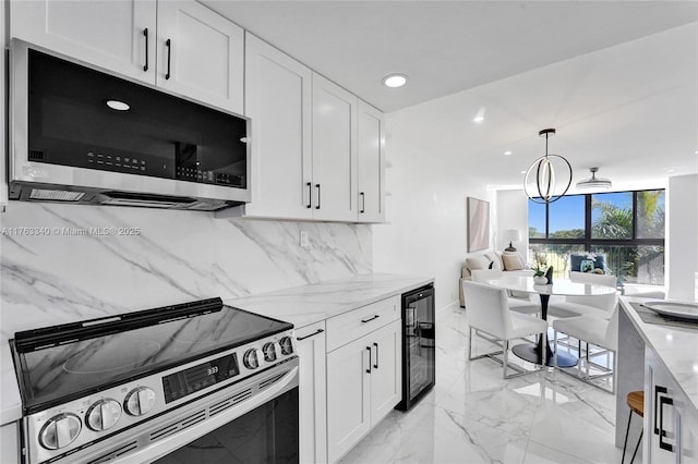 kitchen featuring tasteful backsplash, appliances with stainless steel finishes, beverage cooler, and white cabinetry