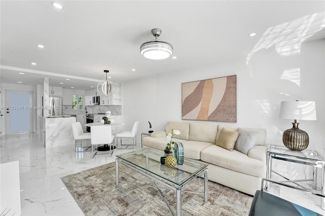living room featuring marble finish floor and recessed lighting