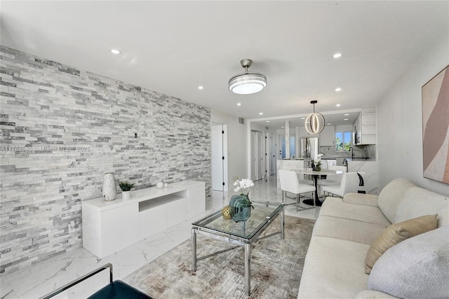 living area with visible vents, marble finish floor, and recessed lighting