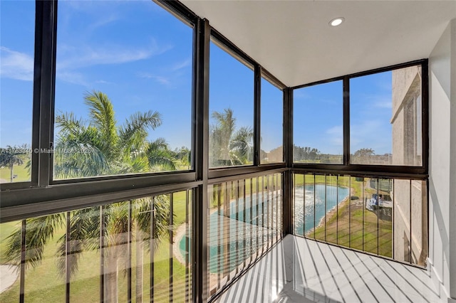 unfurnished sunroom featuring a water view
