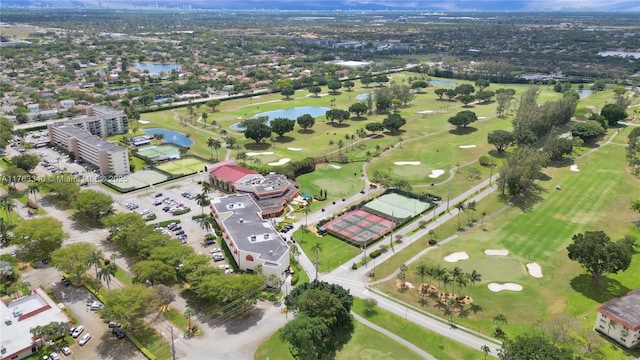 drone / aerial view featuring view of golf course and a water view
