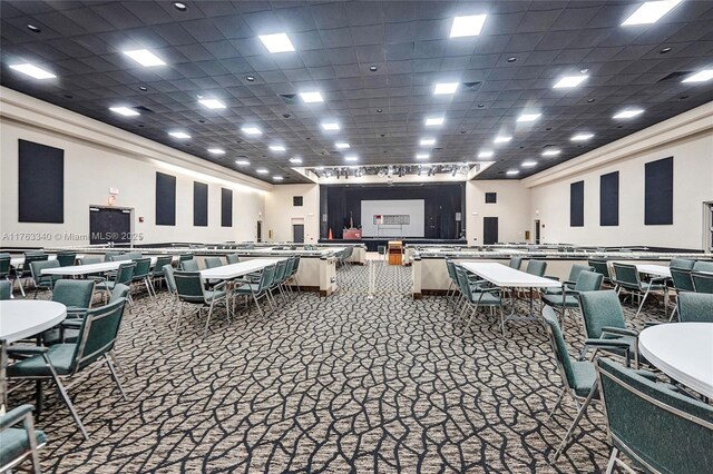 interior space featuring carpet flooring and a drop ceiling