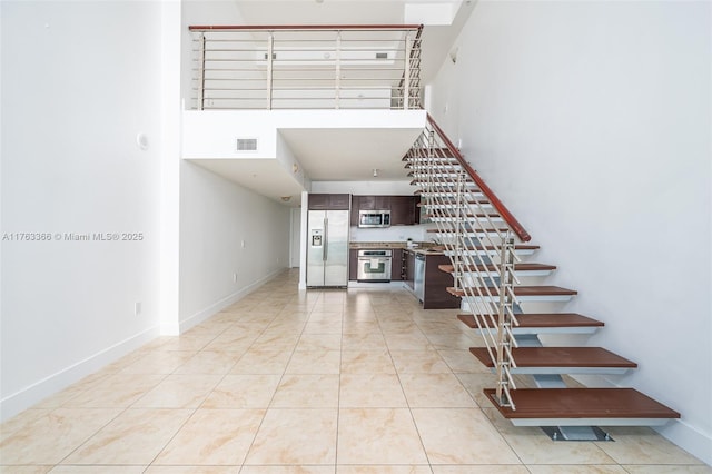 41 SE 5th St Unit 1815, Miami, FL 33131 - stairs featuring a towering ceiling and baseboards