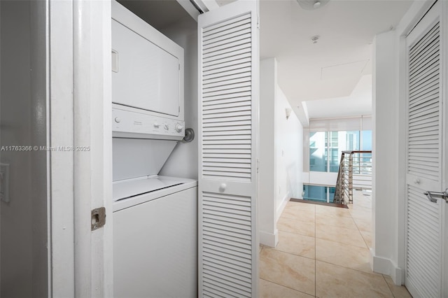 41 SE 5th St Unit 1815, Miami, FL 33131 - laundry area with stacked washer and clothes dryer, baseboards, and light tile patterned flooring