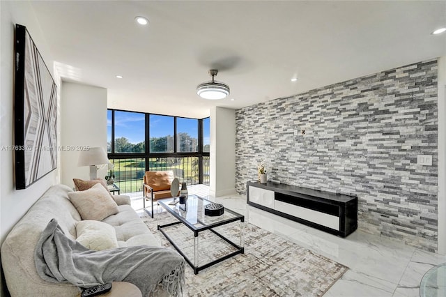 living room with recessed lighting, marble finish floor, and floor to ceiling windows