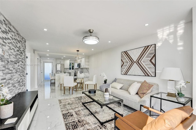 living area with recessed lighting and marble finish floor