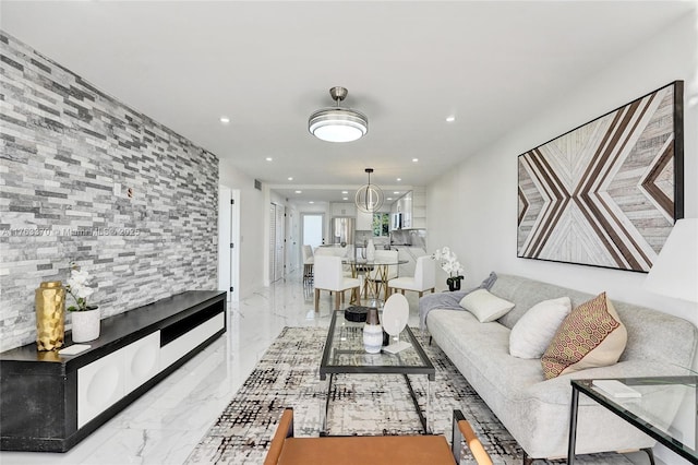 living area with recessed lighting and marble finish floor