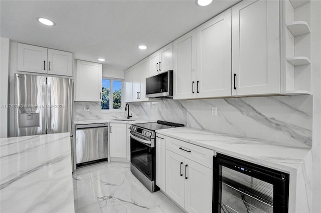 kitchen featuring beverage cooler, light stone countertops, open shelves, stainless steel appliances, and white cabinets