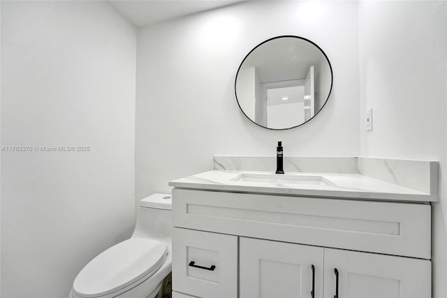 bathroom featuring toilet and vanity