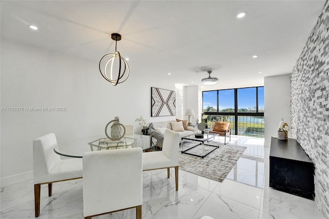 dining area featuring recessed lighting, marble finish floor, and expansive windows