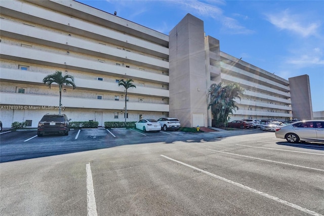 view of building exterior featuring uncovered parking