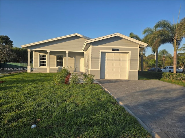 view of front facade featuring decorative driveway, a front yard, a porch, and an attached garage