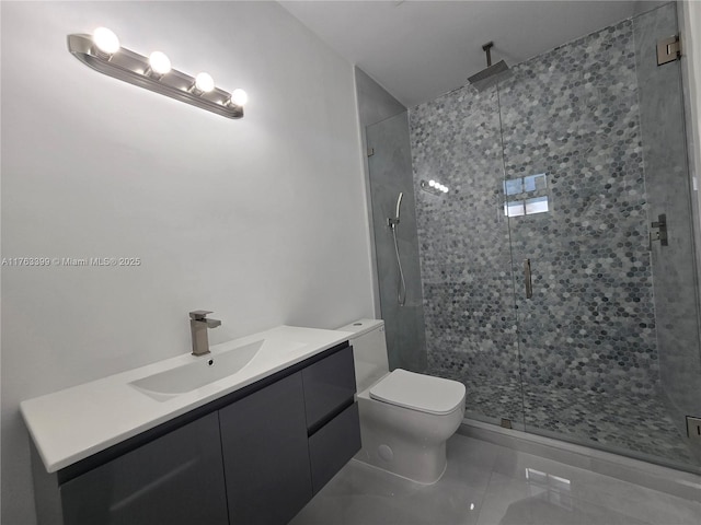 full bathroom featuring vanity, a shower stall, toilet, and tile patterned floors