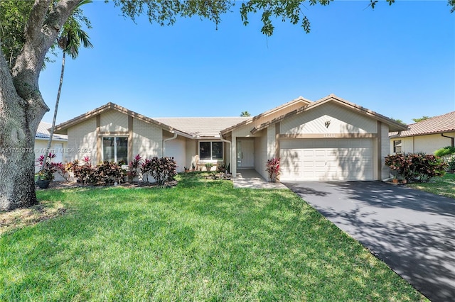 ranch-style home featuring a tile roof, a front lawn, a garage, and driveway