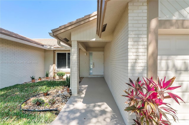 property entrance featuring brick siding