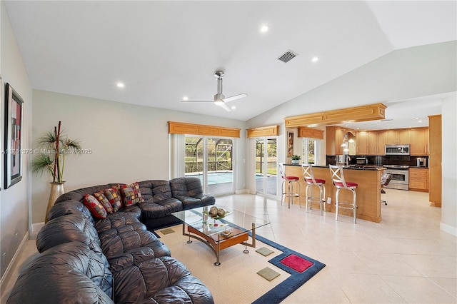 living area featuring visible vents, ceiling fan, vaulted ceiling, light tile patterned floors, and recessed lighting