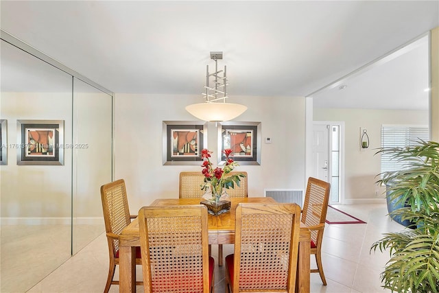 dining area featuring visible vents, baseboards, and light tile patterned flooring