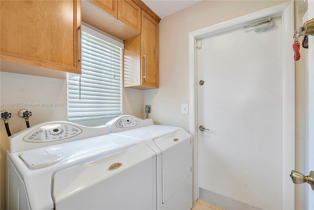 clothes washing area with washer and clothes dryer and cabinet space