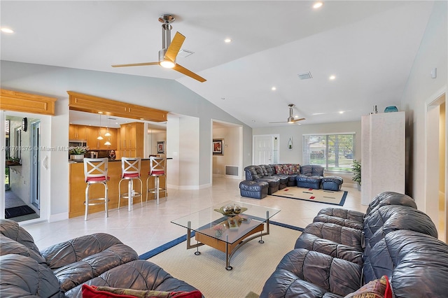 living room featuring light tile patterned flooring, visible vents, ceiling fan, and vaulted ceiling