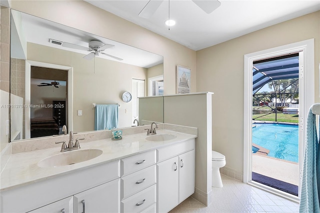 bathroom featuring a sink, double vanity, and a ceiling fan