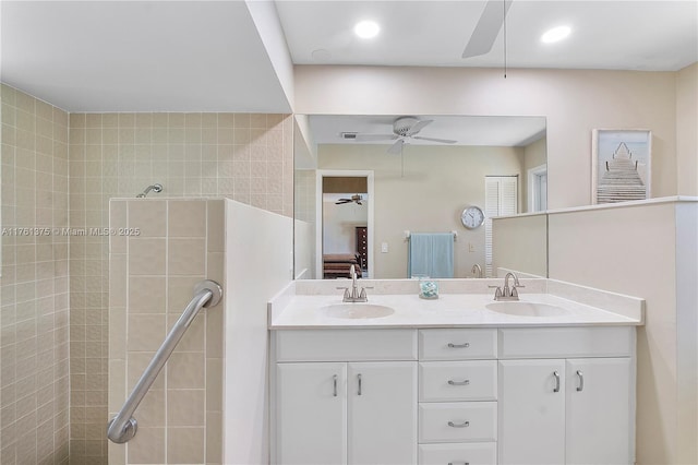 ensuite bathroom with a sink, ensuite bath, double vanity, and ceiling fan