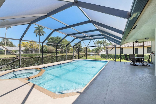 view of pool featuring glass enclosure, a patio, outdoor dining area, and a pool with connected hot tub