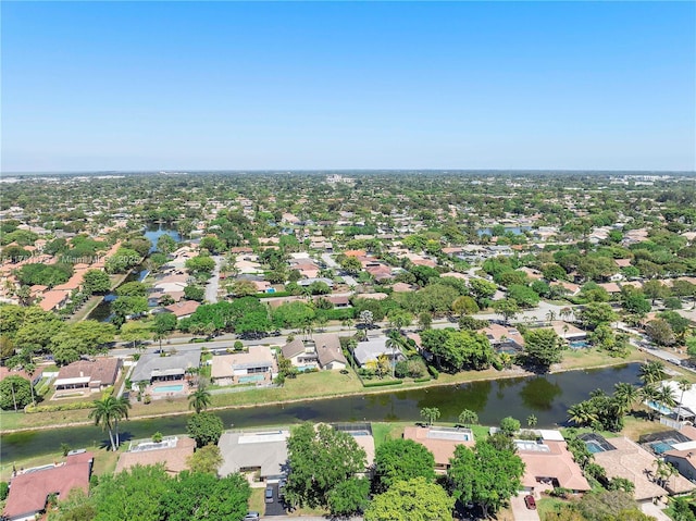 drone / aerial view featuring a residential view and a water view