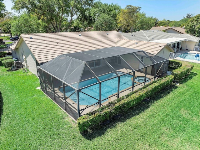 outdoor pool featuring a yard, central air condition unit, and a lanai