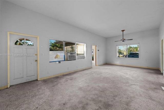 unfurnished living room with baseboards, carpet floors, and ceiling fan