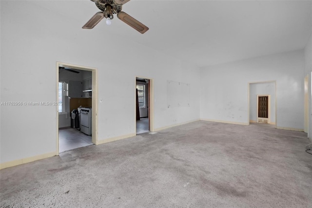 carpeted empty room featuring baseboards and a ceiling fan