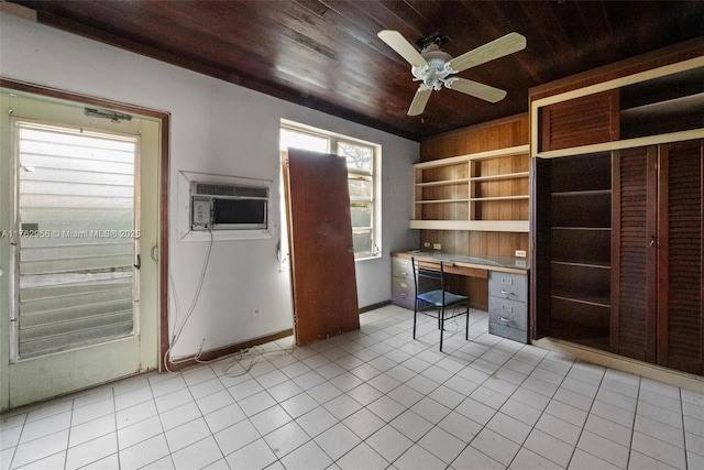 unfurnished office featuring wood ceiling, light tile patterned floors, built in study area, a wall mounted AC, and a ceiling fan