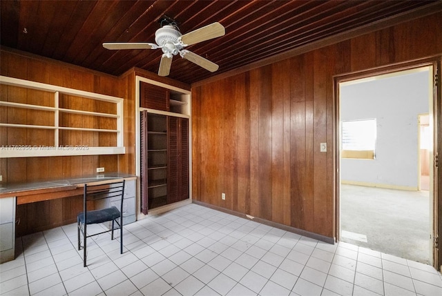 unfurnished office featuring wooden ceiling, built in shelves, wood walls, and built in study area