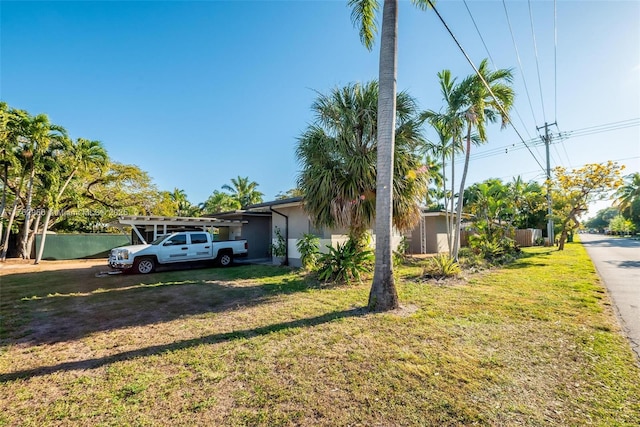 view of front of home with a front yard and stucco siding