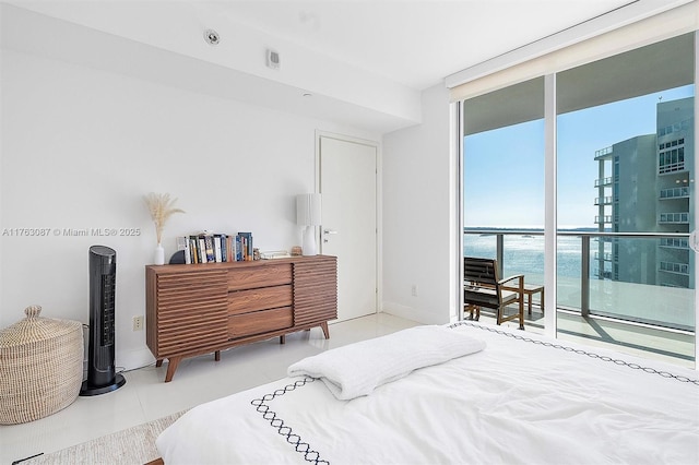 tiled bedroom with access to outside, a water view, baseboards, and expansive windows