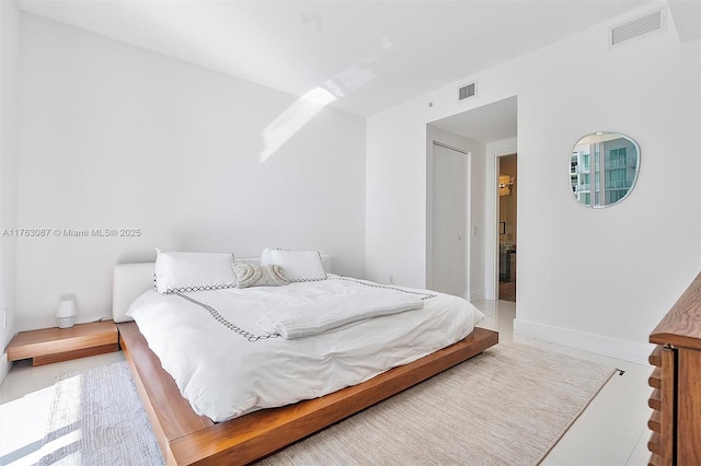 bedroom featuring visible vents and baseboards