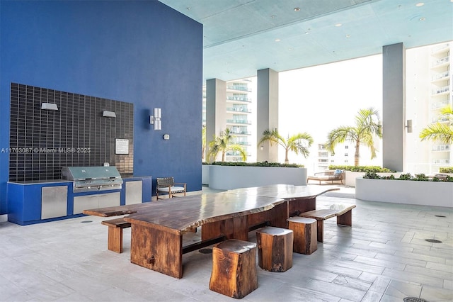 view of patio with an outdoor kitchen and a grill