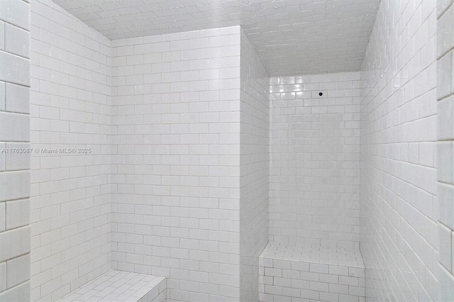 full bath with a tile shower