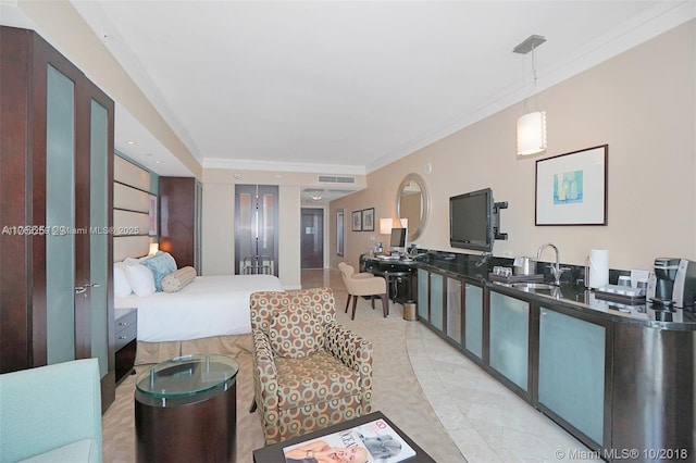 bedroom featuring ornamental molding, visible vents, and a sink