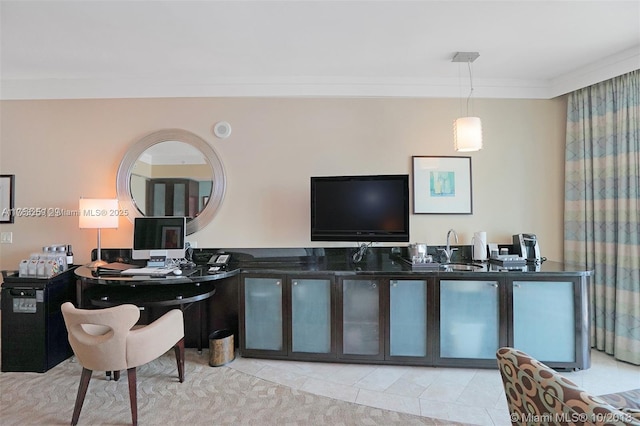 tiled home office with ornamental molding and a sink