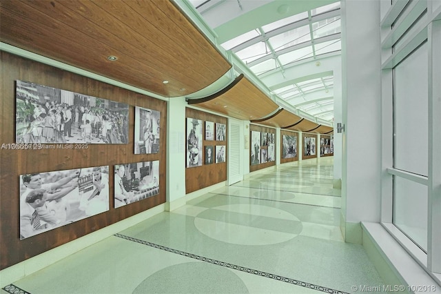 hallway featuring wood ceiling and speckled floor