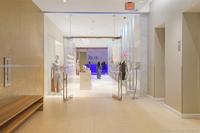 corridor featuring floor to ceiling windows and recessed lighting