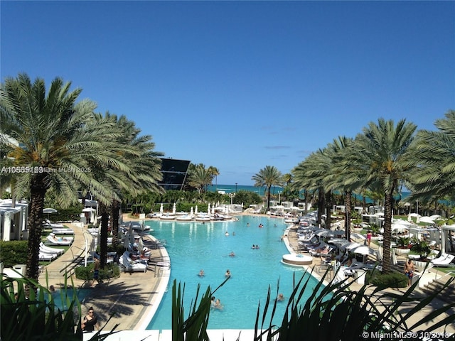 view of swimming pool featuring a water view