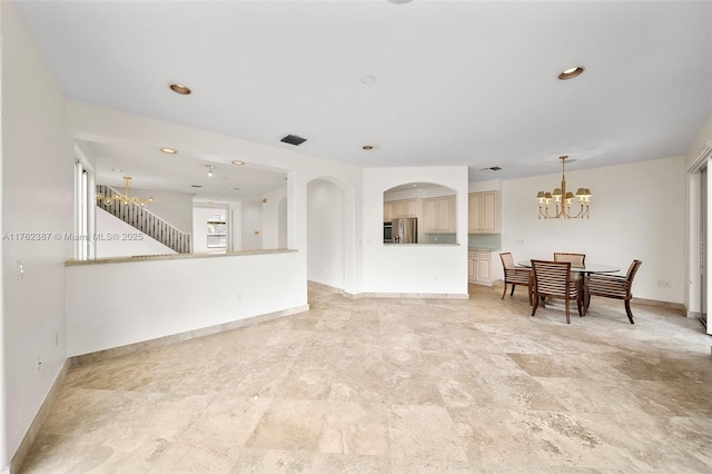 unfurnished living room featuring recessed lighting, visible vents, baseboards, and a chandelier