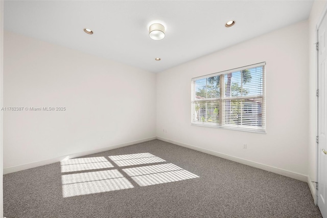 spare room featuring recessed lighting, baseboards, and carpet