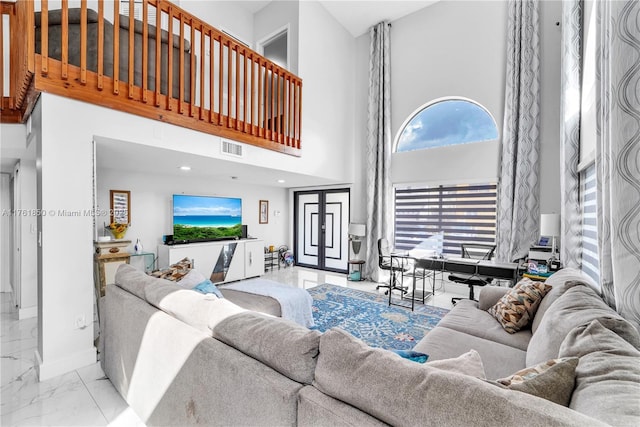 living area with visible vents, marble finish floor, french doors, baseboards, and a towering ceiling